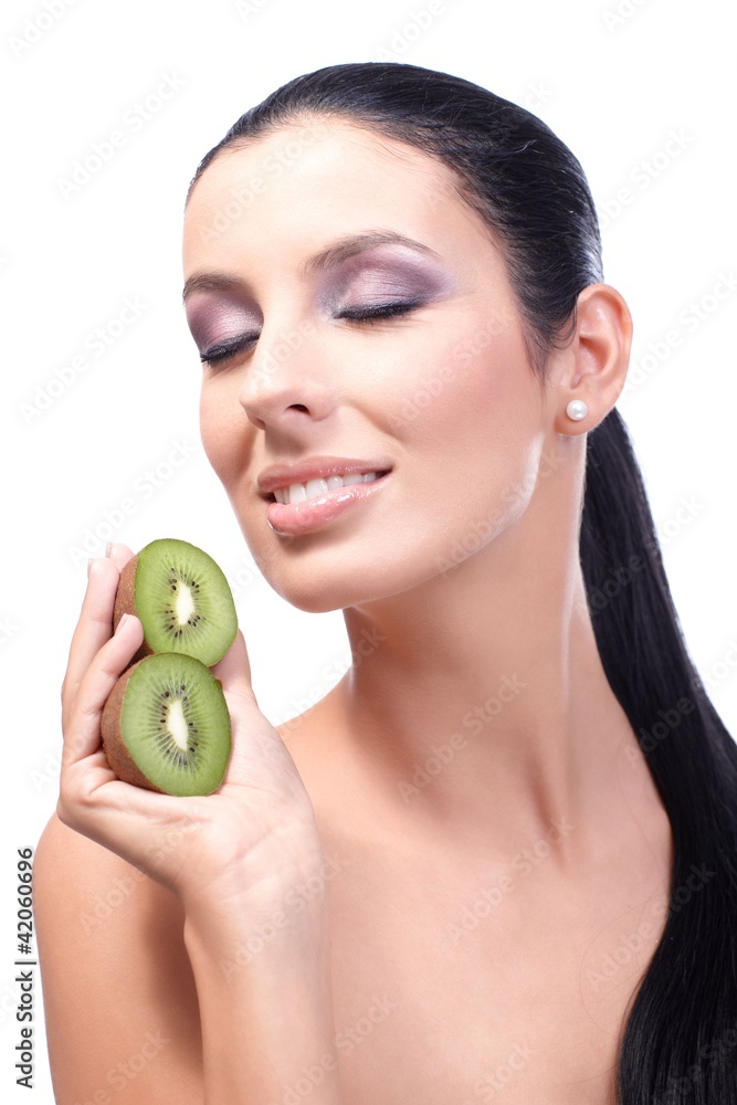 Young woman smiling eyes closed holding kiwi Young woman smiling eyes closed holding kiwi