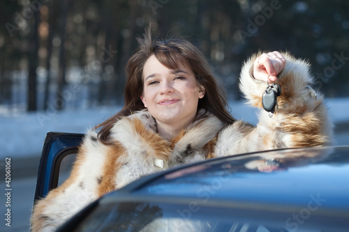 Happy woman with her car