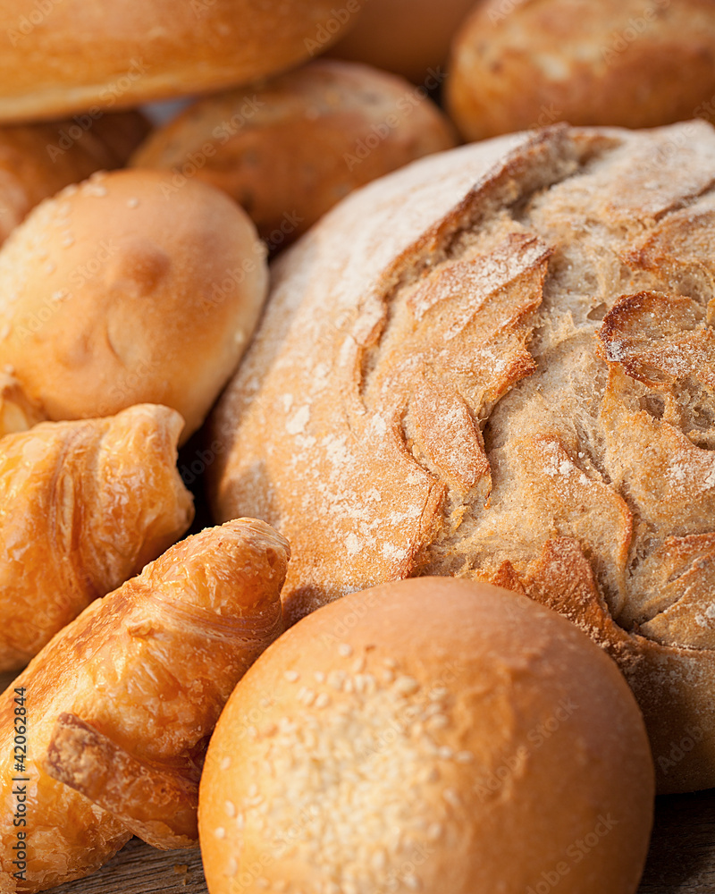 assortment of baked bread on wood table assortment of baked bread on wood table