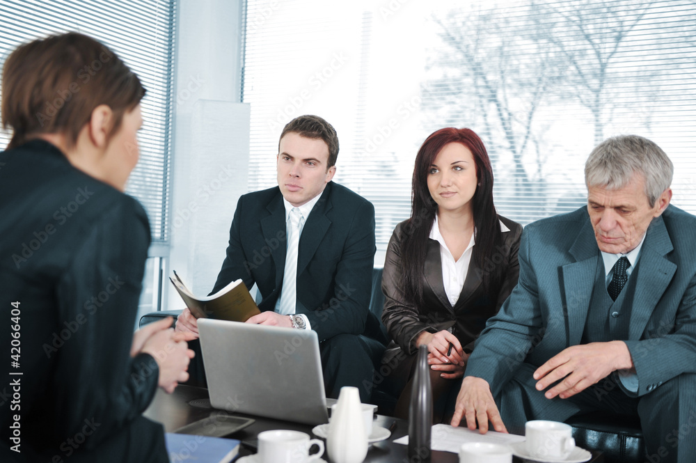 Businesswoman in an interview with three business people Businesswoman in an interview with three business people
