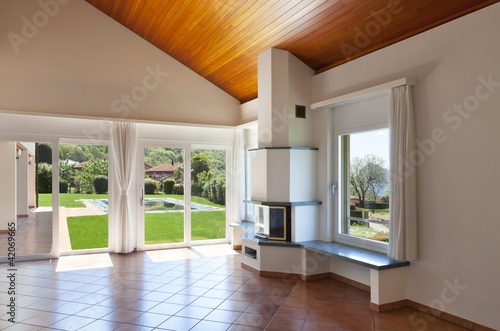 room with terracotta floor windows overlooking the garden