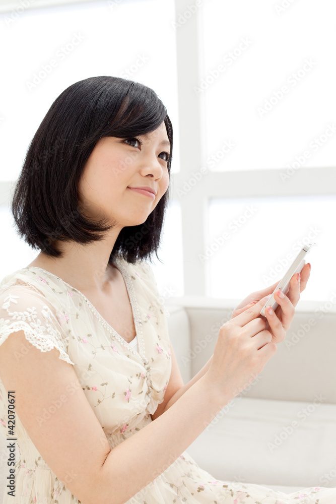 Beautiful young woman using a mobile phone. Portrait of asian. Beautiful young woman using a mobile phone. Portrait of asian.