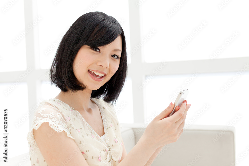 Beautiful young woman using a mobile phone. Portrait of asian. Beautiful young woman using a mobile phone. Portrait of asian.