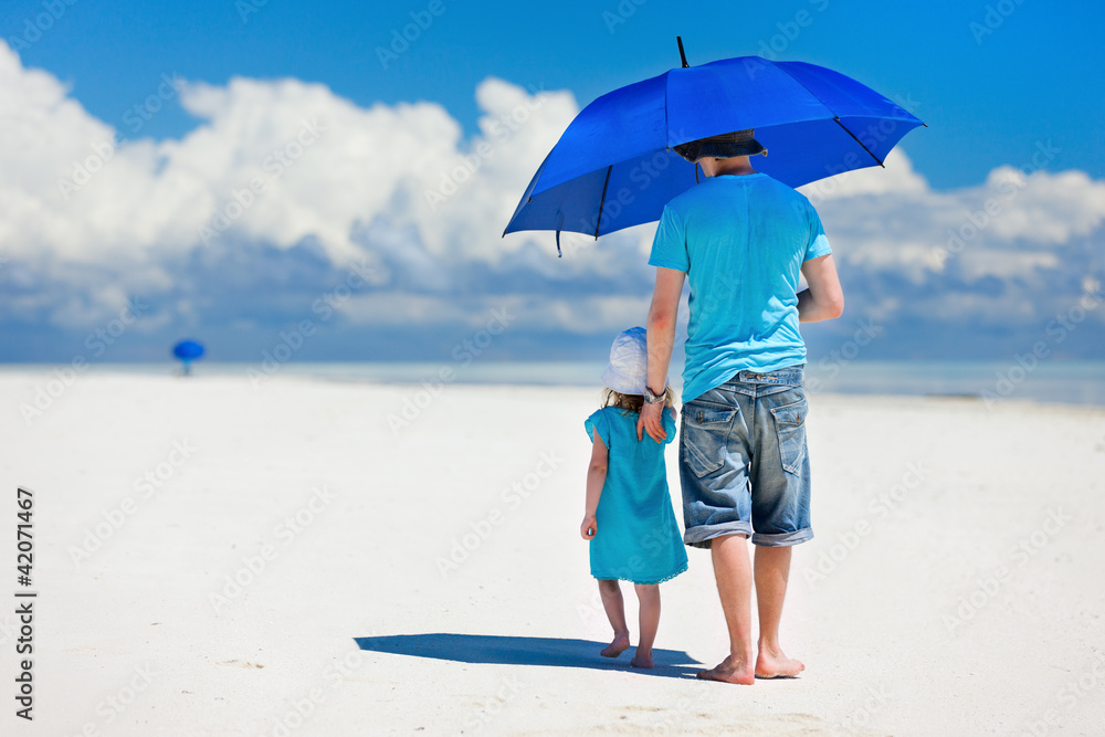 Father and daughter walking at beach Father and daughter walking at beach