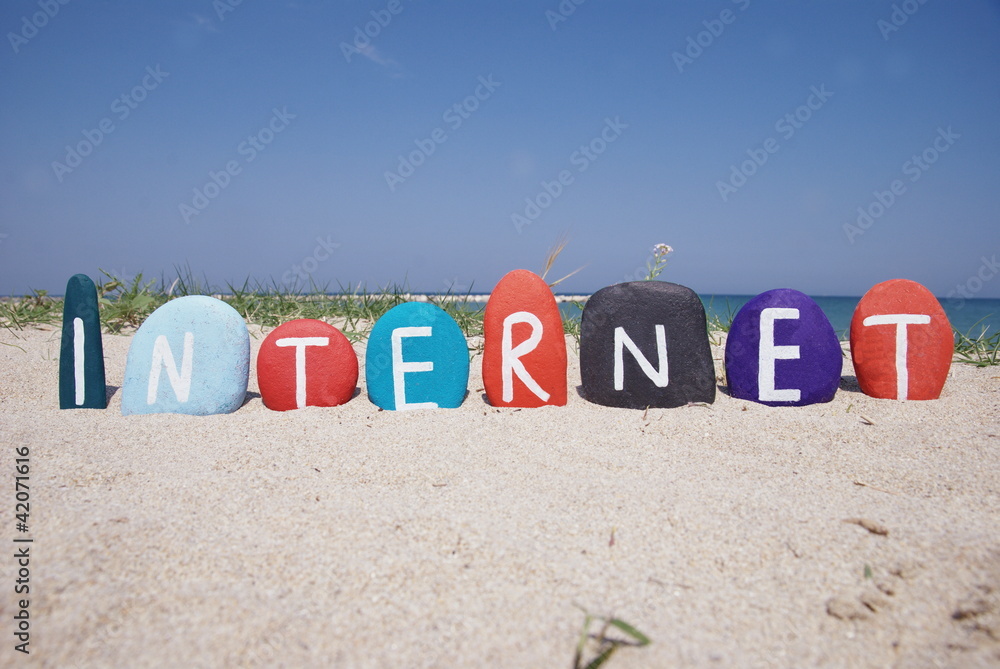 Internet, word on colourful stones over the sand Internet, word on colourful stones over the sand