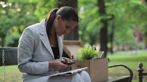 Unemployed businesswoman looking for job in newspaper