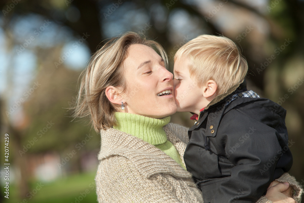Fototapeta premium portrait of mid adult woman and her little boy outdoors
