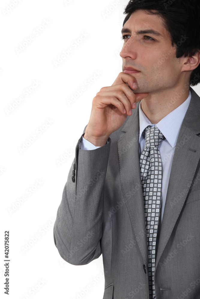 businessman thinking and holding his chin businessman thinking and holding his chin