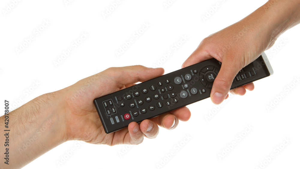 Man giving woman a black remote Man giving woman a black remote