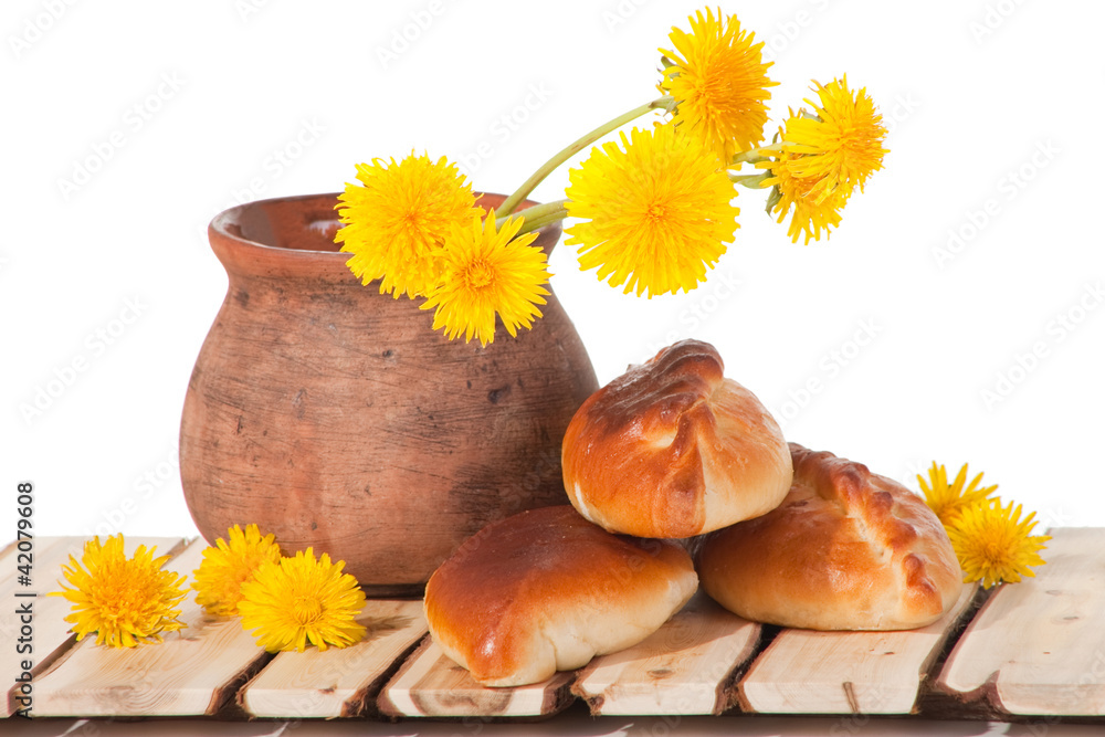 three pies and dandelions in clay pot three pies and dandelions in clay pot