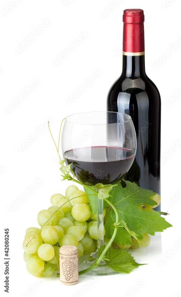 Red wine glass, bottle and grapes