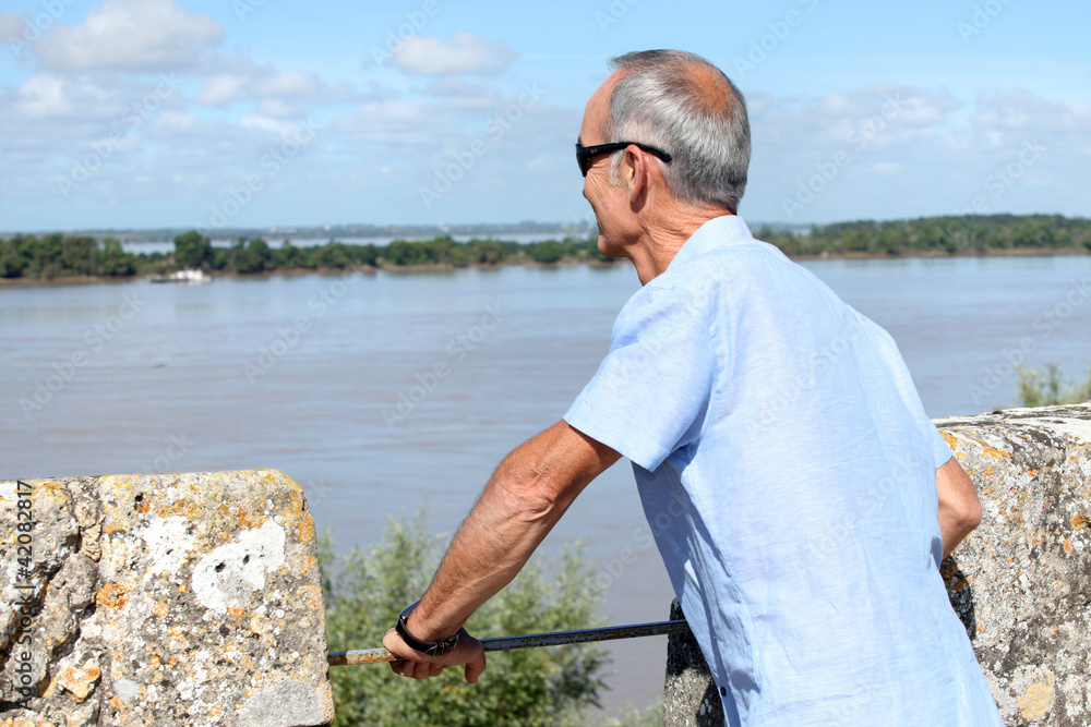 Senior tourist looking at water Senior tourist looking at water