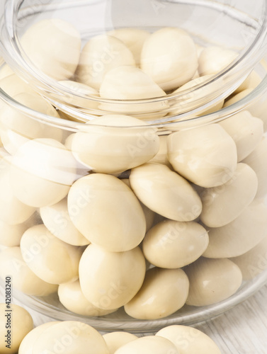 white chocolate balls with almond heart. in a glass jar