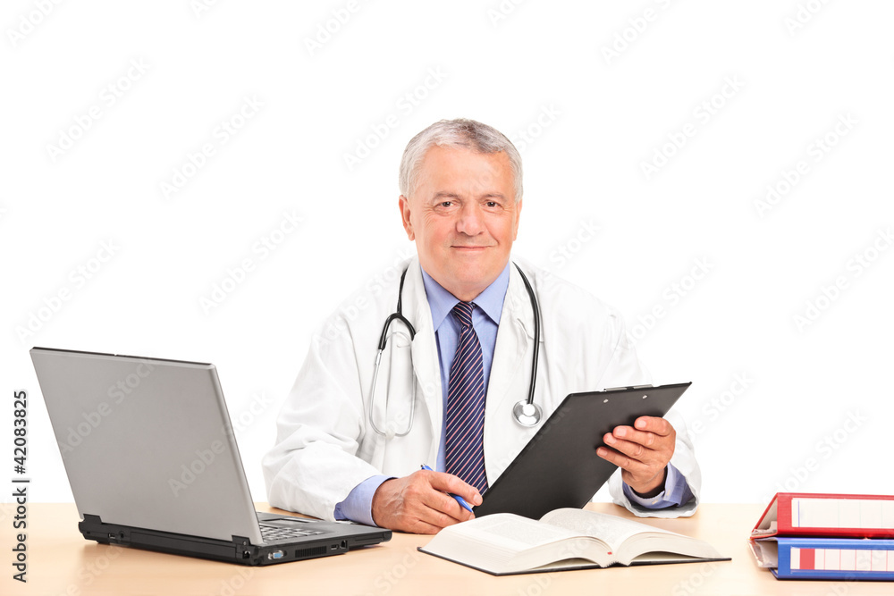 A mature doctor posing in his office A mature doctor posing in his office