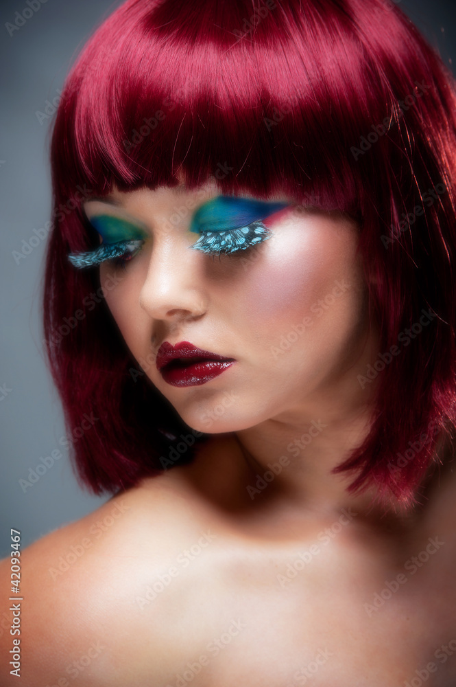 Beautiful young female with aurburn hair and blue eye makeup Beautiful young female with aurburn hair and blue eye makeup