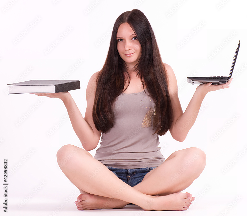 Young female student with computer and book Young female student with computer and book