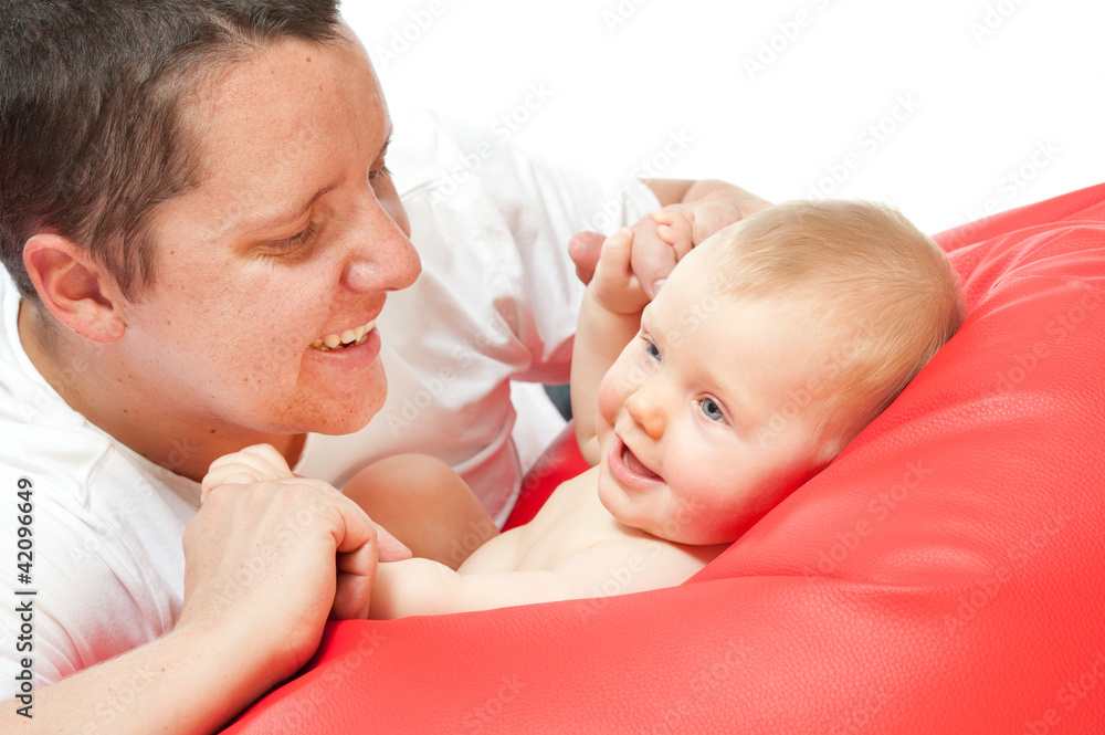 father with baby on red sofa father with baby on red sofa