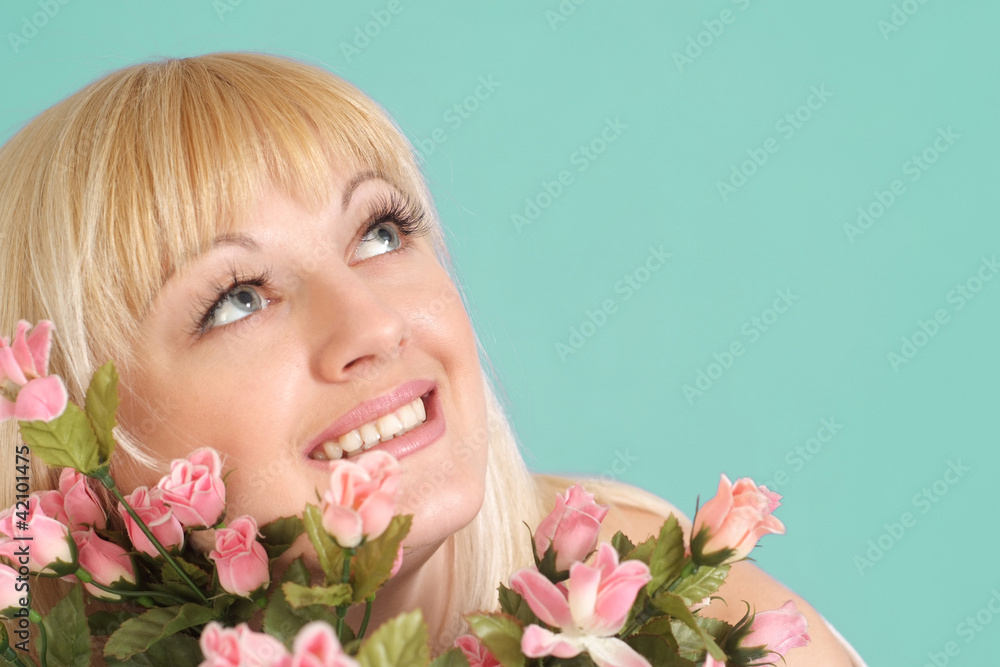 Portrait of a beautiful blonde Caucasian smile lady with flowers Portrait of a beautiful blonde Caucasian smile lady with flowers