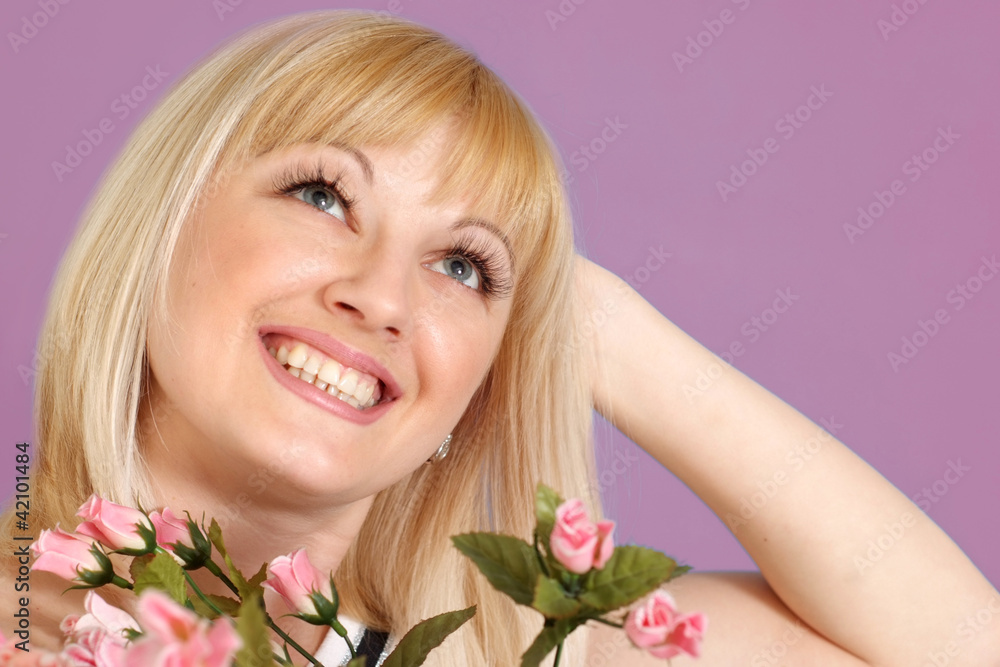 Portrait of a beautiful blonde Caucasian happy lady with flowers Portrait of a beautiful blonde Caucasian happy lady with flowers