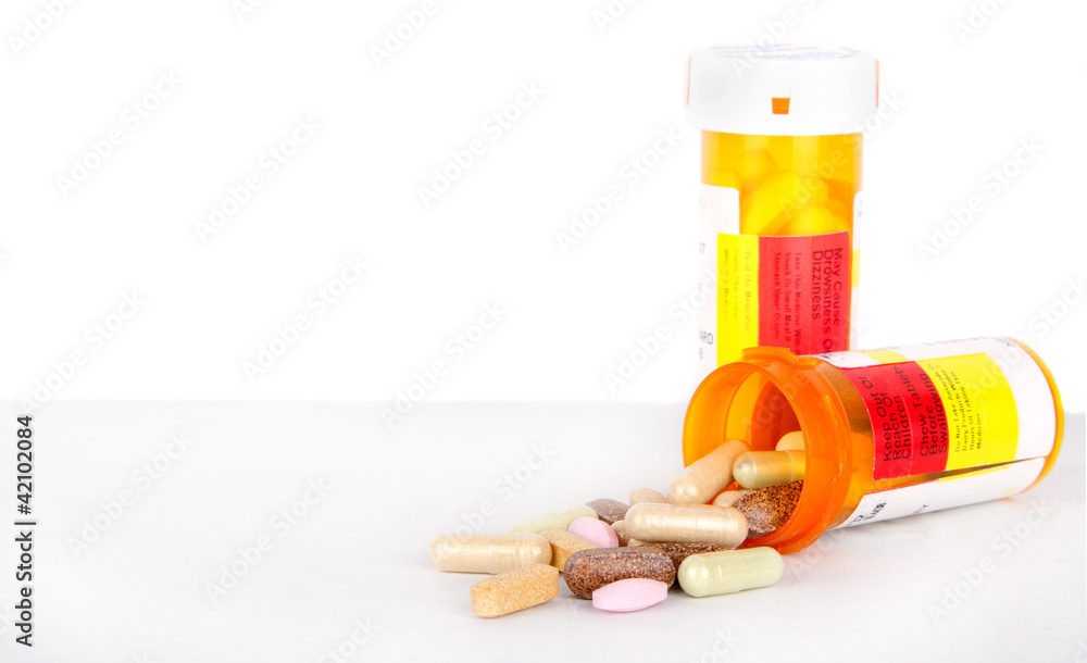 Pills spilling out of a perscription bottle Pills spilling out of a perscription bottle