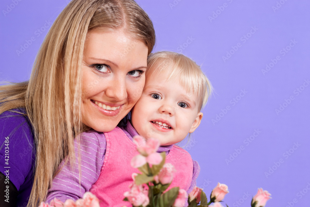 Pretty Caucasian mummy and daughter with flowers Pretty Caucasian mummy and daughter with flowers