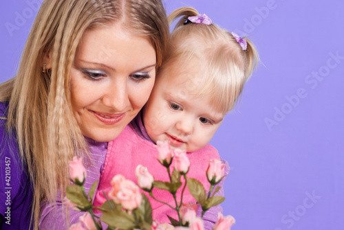 Pretty Caucasian mother and daughter with flowers