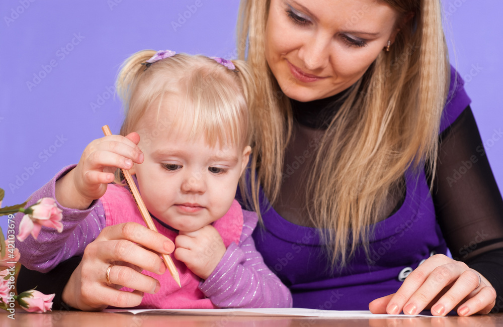 Happy Caucasian mom with her good daughter play with a pencils