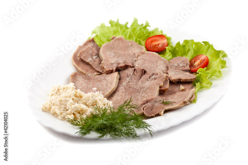 Boiled veal tongue with greens and a horse-radish