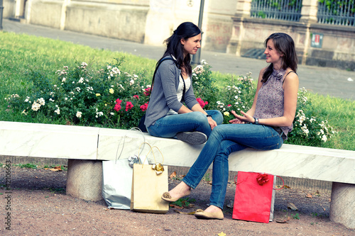two girls with colored bags outdoor