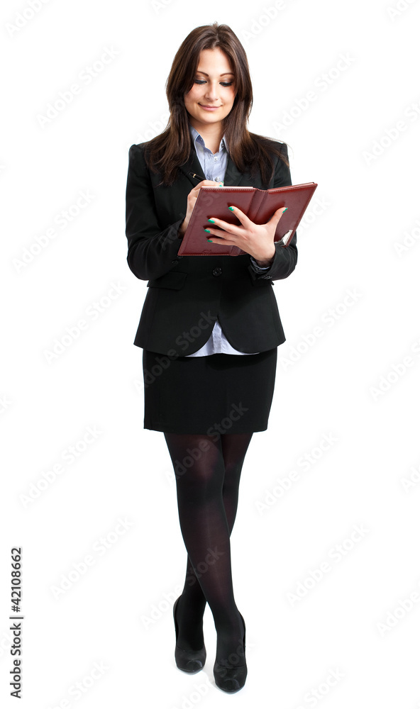 Full length businesswoman writing on agenda Full length businesswoman writing on agenda