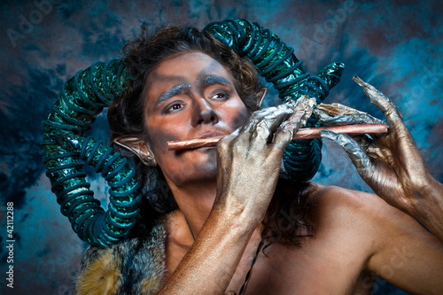 Faun playing the flute photo