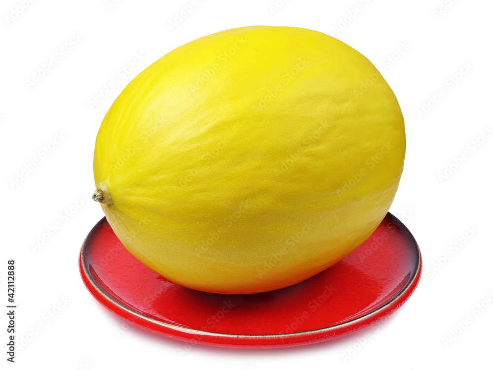 Yellow melon on a red plate Yellow melon on a red plate