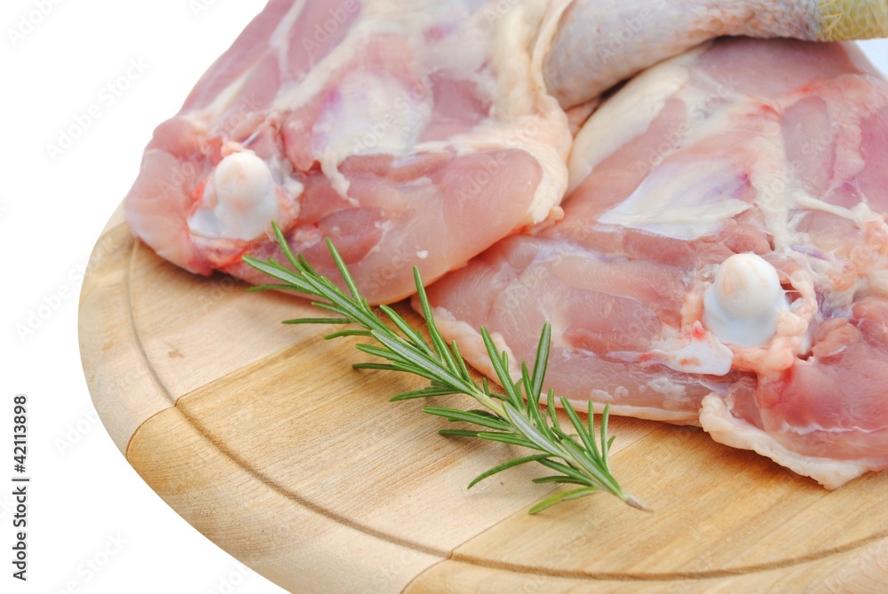chicken legs on a wooden cutting board isolated on white chicken legs on a wooden cutting board isolated on white