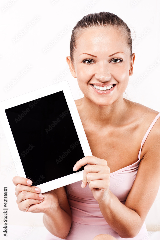 Smiling young beautiful woman with a tablet pc computer Smiling young beautiful woman with a tablet pc computer
