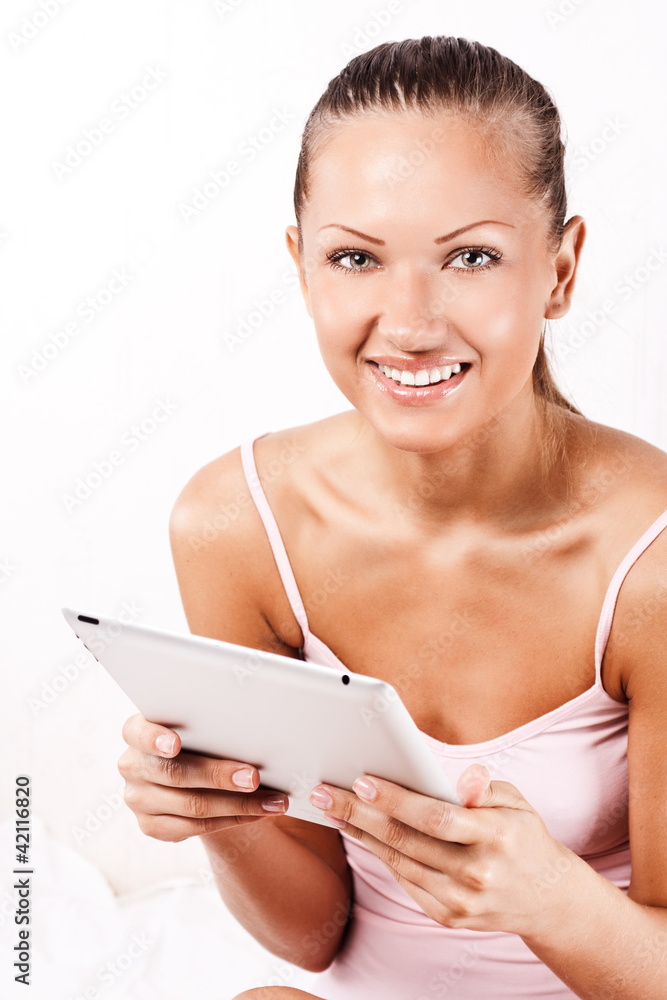 Smiling young beautiful woman with a tablet pc computer Smiling young beautiful woman with a tablet pc computer