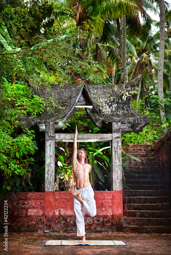 Yoga near temple in jungle photo