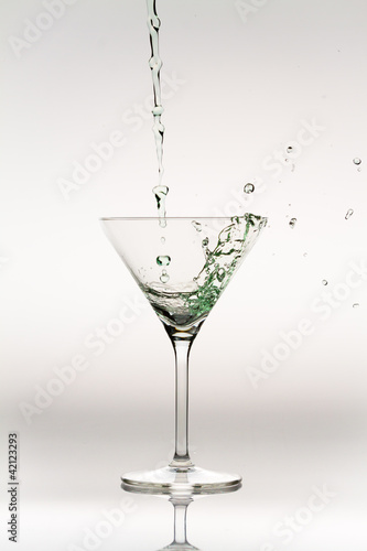 Splash of liquor inside a cocktail glass