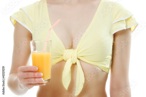 A slender girl with a glass of juice