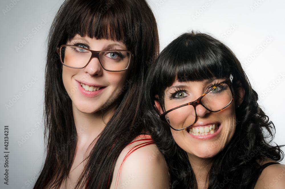 Two smiling girls with crooked glasses Stock Photo | Adobe Stock