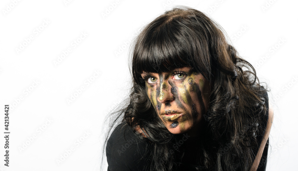 Headshot of darkhaired girl with facepaint streaks Headshot of darkhaired girl with facepaint streaks