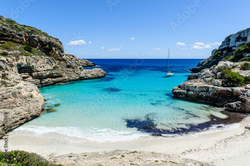 Sailing boat at anchor. Paradise wild bay and beach.