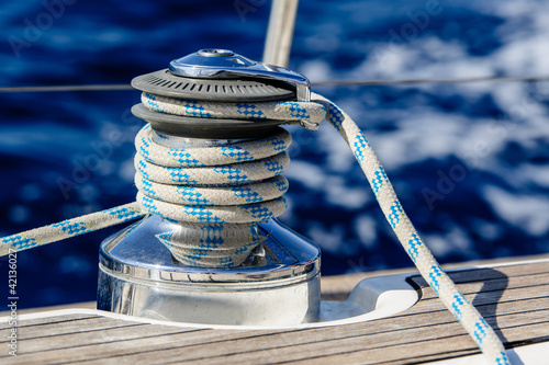 Sailing boat winch with rope closeup photo