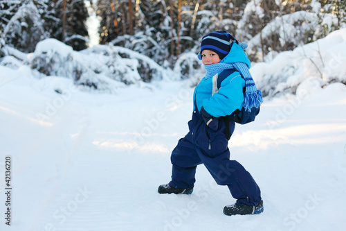 Little boy in forest. Winter day. This boy is 5 years old.