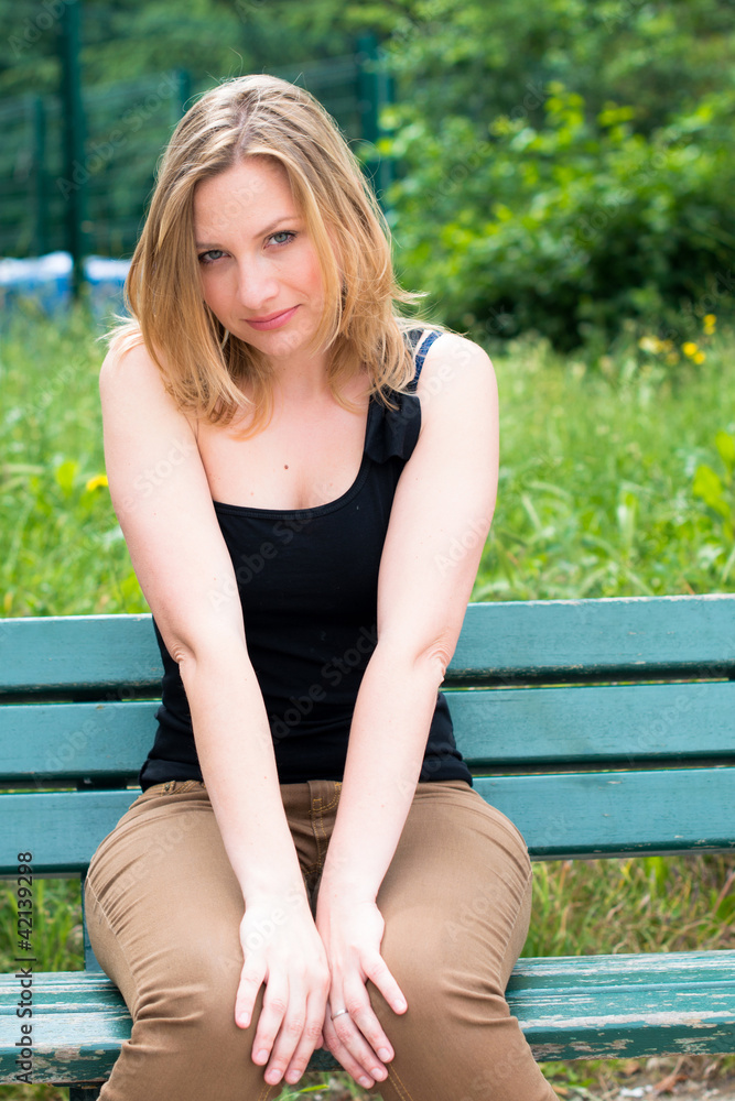 woman sitting on the bench in park woman sitting on the bench in park