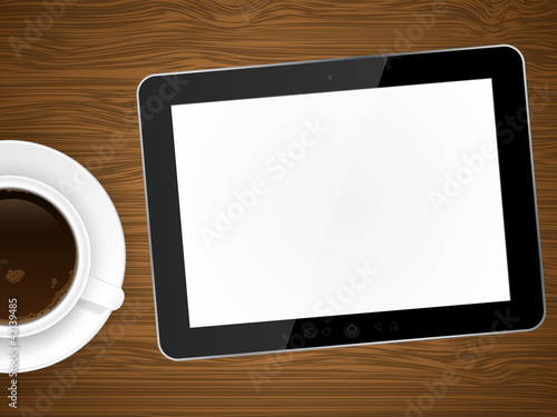 Coffee cap and tablet pc on wooden background.