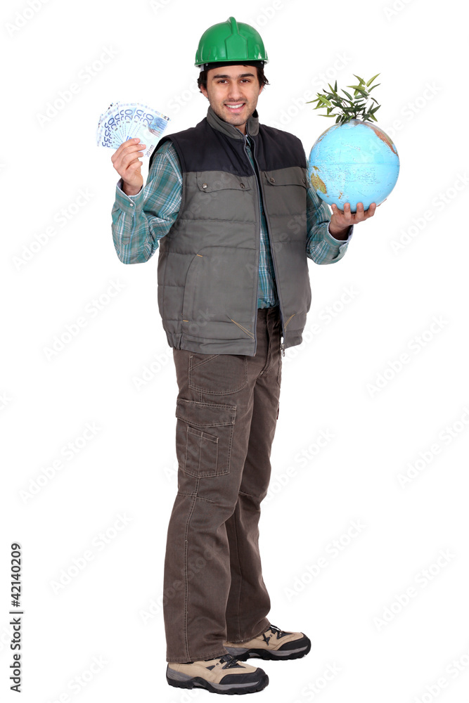 Construction worker standing with cash and a globe