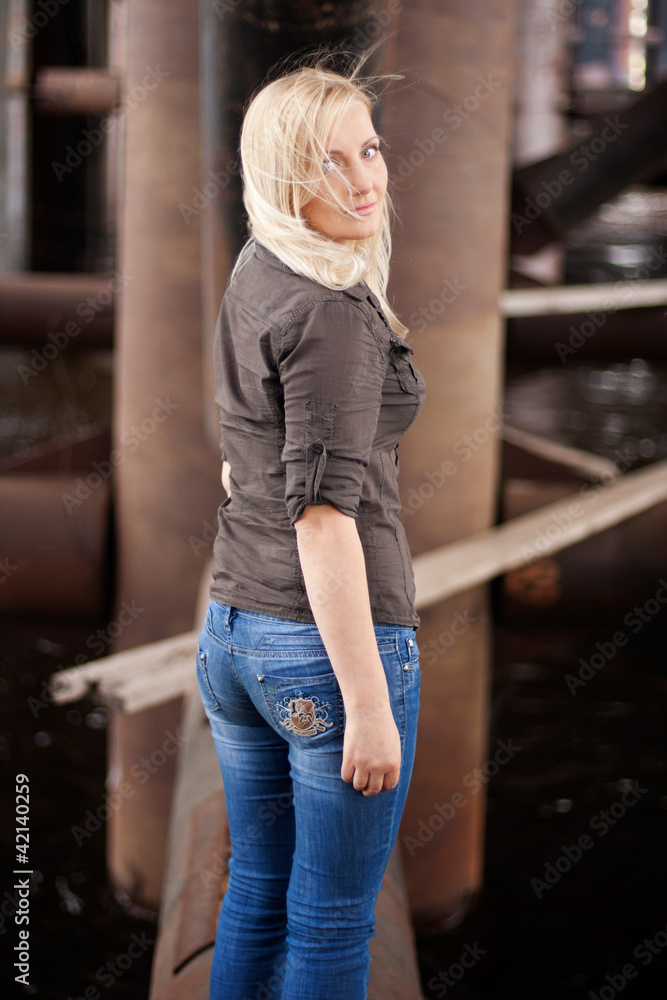 Young woman posing in industrial area