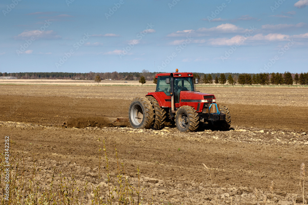 Obraz premium tractor cultivated fields