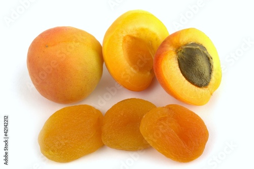 Fresh and sun dried apricots on white background.