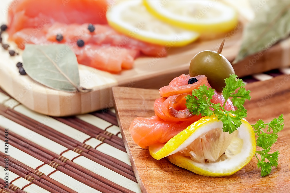 Salmon snack on the wooden plate, studio shot Salmon snack on the wooden plate, studio shot